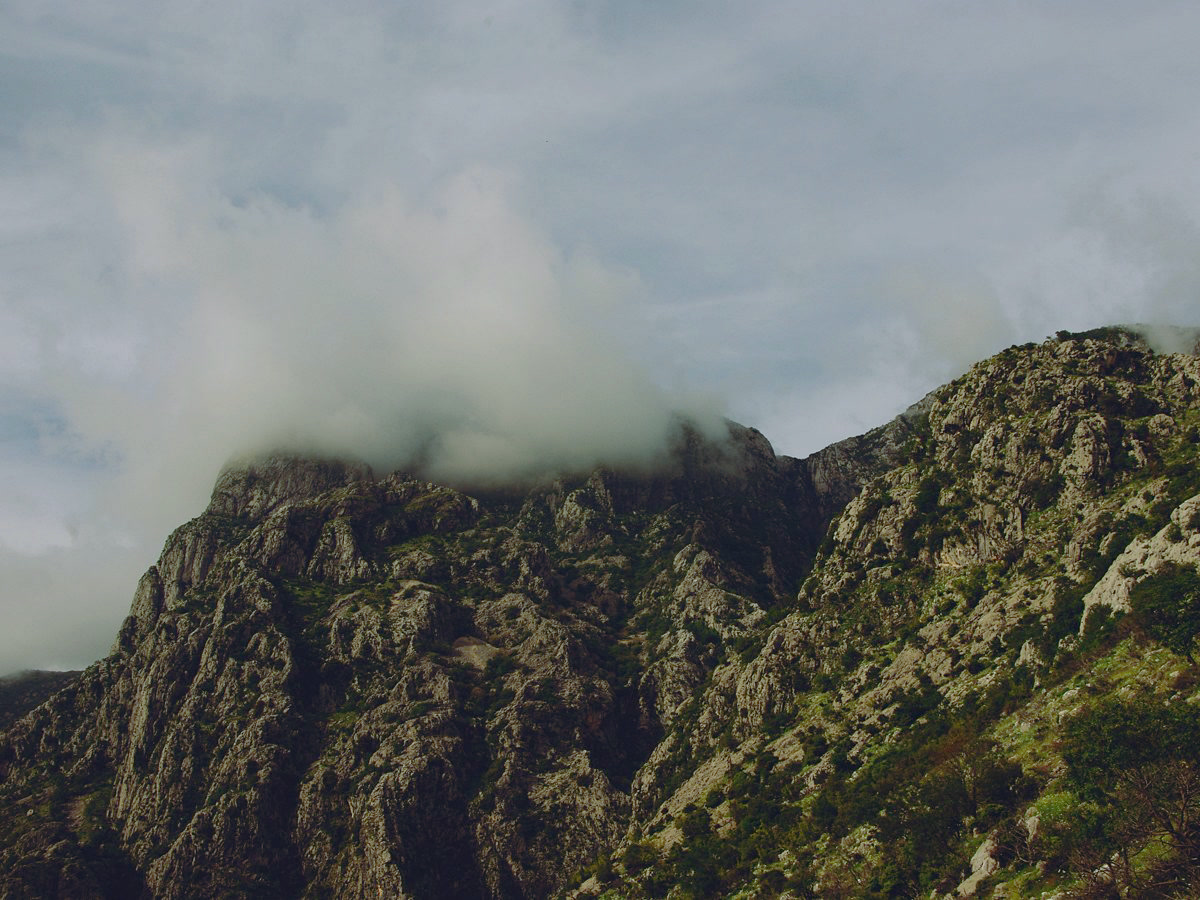 A limestone karst ridge in Durmitor, cloud draped over the summit.